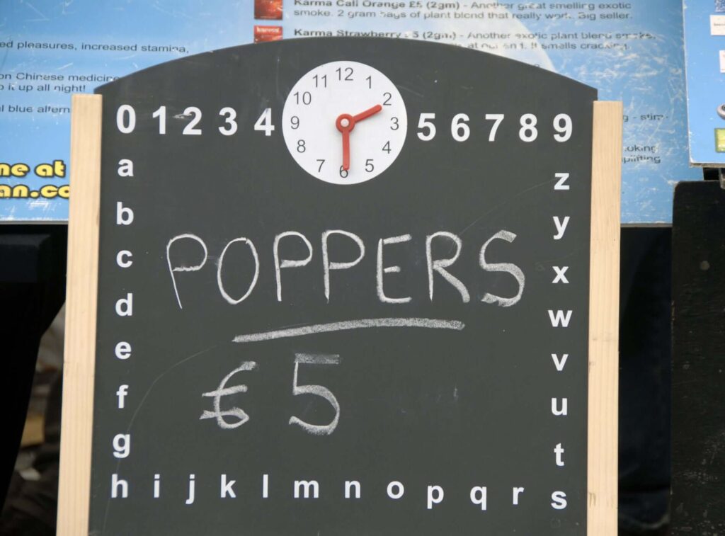 A chalkboard displaying poppers for sale at a local store – where to buy poppers locally and online.