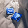 Durex-XL 1 Durex Natural condom individual foil wrappers on grey fabric – discreet lubricated latex condoms