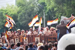 What is the bear community? A diverse group of bear community members socialising outdoors at a Pride gathering under the Bear Pride Flag.